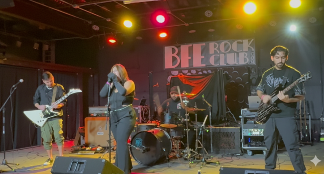 Second Illusion band performing live at BFE Rock Club with two vocalists, drummer, and guitarists under colorful stage lights.